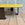 In Stock Offset Coffee Table with Blackened Base and Yellow Leather Top (SOLD)