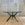 In Stock Vitruvian Tri Table with Blackened Base and Glass Top, 48"Dia