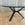 In Stock Vitruvian Tri Table with Blackened Base and Glass Top, 48"Dia