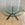 In Stock Vitruvian Tri Table with Blackened Base and Glass Top, 48"Dia